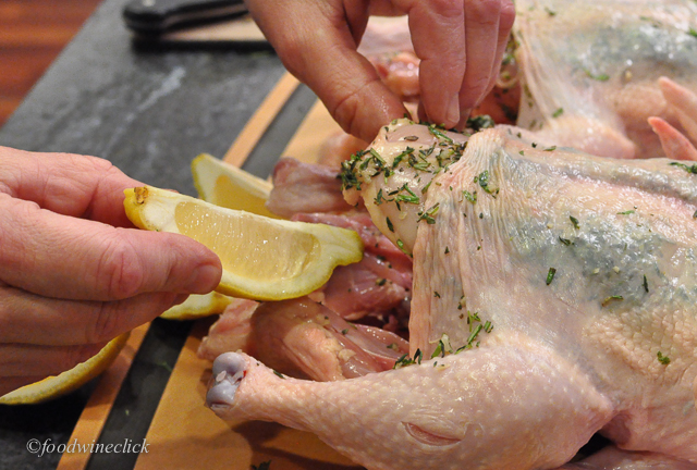 Herbs between the skin and breast, cavity stuffed with lemon