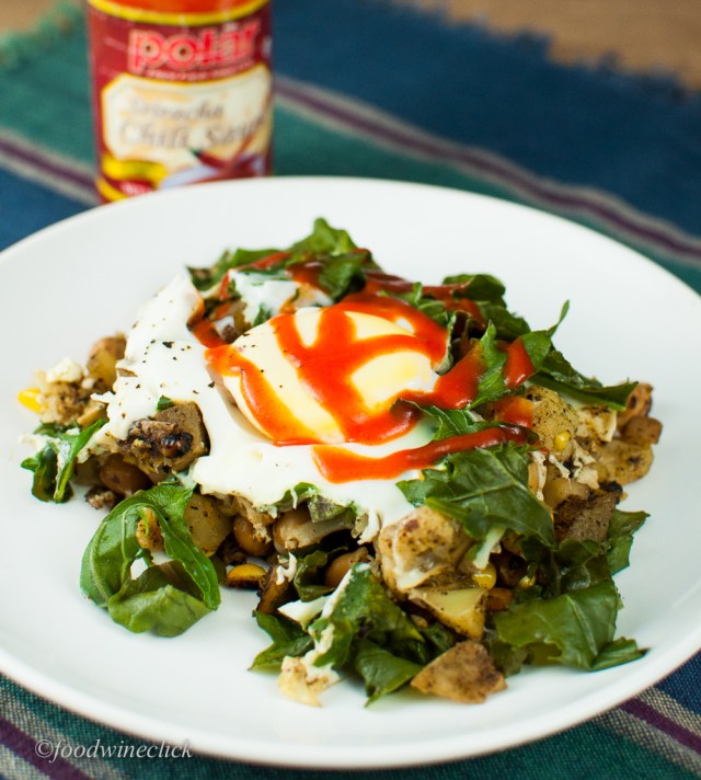 Curry spices and veggies topped with kale and an egg. Then there's the Sriracha!