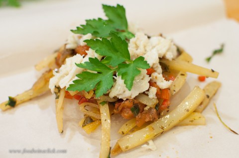 Layer fish, veggies, and top with crab