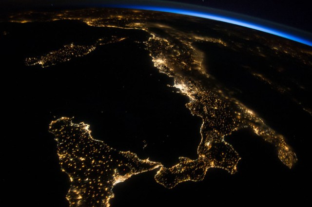 Italy at night as seen by Astronaut Reid Wiseman. Notice the black hole with red center; that's Mt. Etna with lava core! (photo courtesy of NASA)
