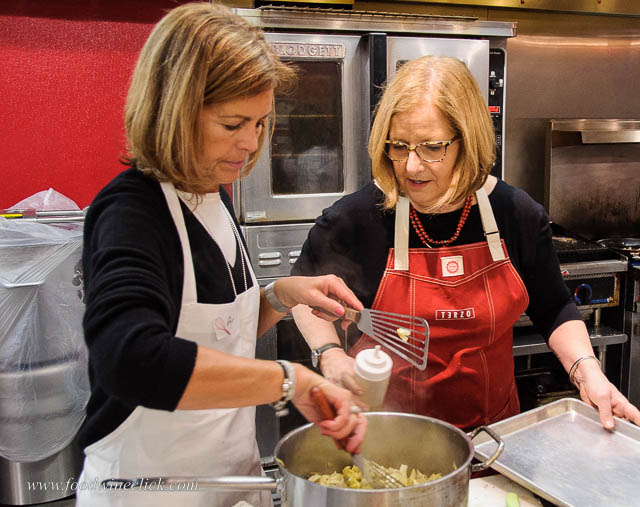 Molly Broder instructing a student at Kitchen in the Market