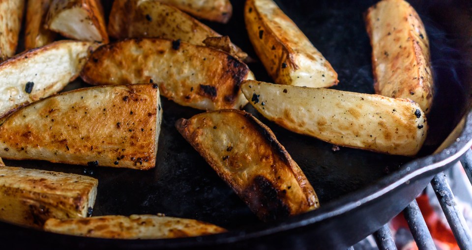 grilled potato wedges in a cast iron skillet