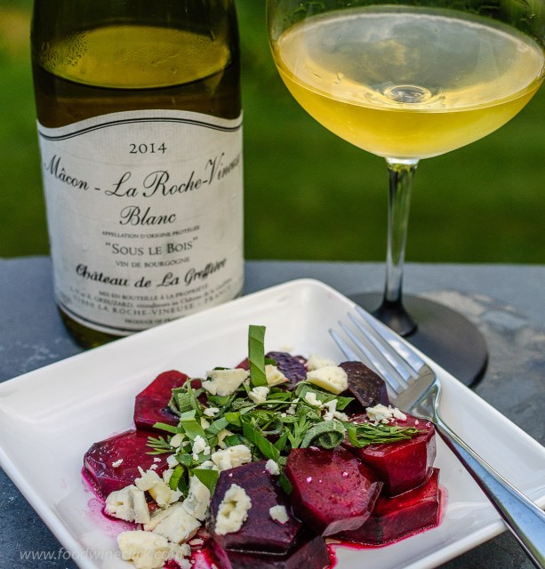 A white Burgundy wine served alongside a beet salad